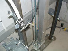 Check level at landing & operation of travel limit, switches, hoist ropes & oil trays